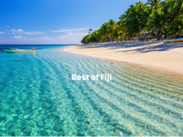 Best of Fiji image of the crystal clear water and a boat near the sandy beach